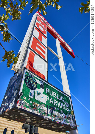 Retro Motel Sign and Stickers Against Blue Sky Low-Angle View Retro Motel Sign and Stickers Against Blue Sky Low-Angle View 126914394