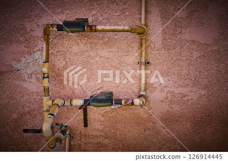 Exposed Industrial Pipes on Stucco Wall Eye-Level Perspective Exposed Industrial Pipes on Stucco Wall Eye-Level Perspective 126914445