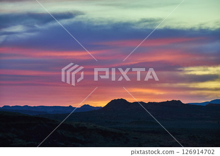 Desert Mountains and Mesas at Sunset with Vibrant Sky Motion Eye Level View Desert Mountains and Mesas at Sunset with Vibrant Sky Motion Eye Level View 126914702