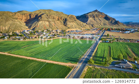 Aerial Farmland and Small Town with Red Rock Mountains Hurricane Utah Fly Over 126914772