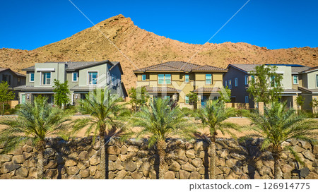 Aerial Fly Through Modern Desert Homes Palm Trees Mountain Backdrop 126914775