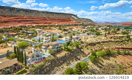 Aerial Suburban Homes and Red Rock Cliffs in Desert Landscape Fly Over 126914819