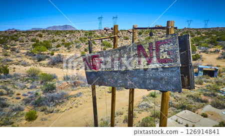 Aerial Abandoned Wooden NOTHING Sign Desert Landscape Power Lines Elevated View Aerial Abandoned Wooden NOTHING Sign Desert Landscape Power Lines Elevated View 126914841
