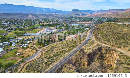 Aerial Highway Winding Through Desert Town and Mountain Range Fly Over Aerial Highway Winding Through Desert Town and Mountain Range Fly Over 126914843