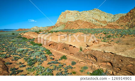 Aerial Fly Over Red Rock Formations Rugged Mountains Desert Vegetation Utah 126914901