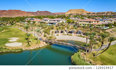 Aerial Luxury Golf Course Homes and Desert Mountains with Lake View Fly Over 126914917