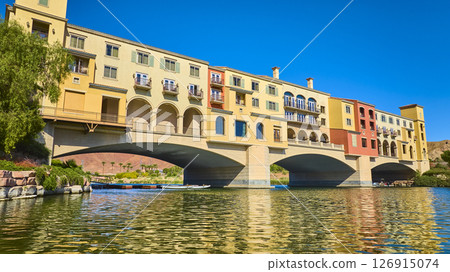 Mediterranean Style Bridge Over Water with Lush Greenery Reflections Low Angle Mediterranean Style Bridge Over Water with Lush Greenery Reflections Low Angle 126915074