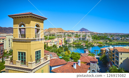 Aerial Mediterranean Village Tower and Lake Oasis in Desert Setting 126915082