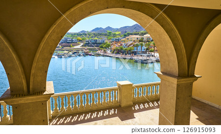 Aerial Fly Through Mediterranean Stone Arches Over Marina and Waterfront Balcony 126915093
