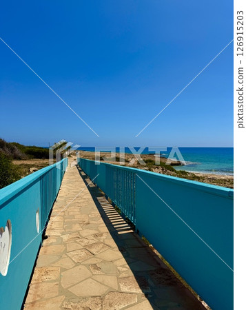 Tourist recreation area. Walking path near the sea. 126915203
