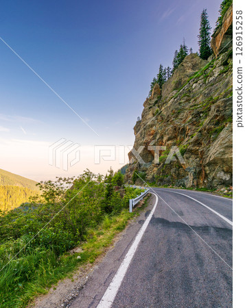 transfagarasan road winding near steep slope. great outdoors of fagaras mountain ridge of romania in summer. popular travel destination of europe on high altitude in morning light 126915258