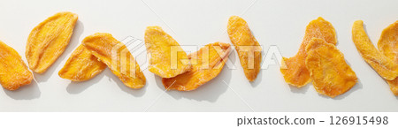 Dried mango chips on a white background Dried mango chips on a white background 126915498