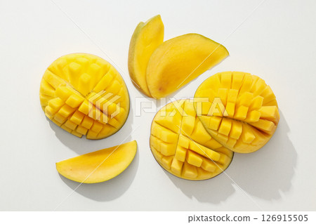 Ripe sliced mango on a white background Ripe sliced mango on a white background 126915505