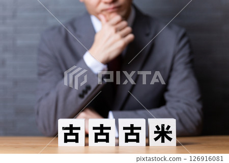 A middle-aged male businessman worried about wearing a suit and old-fashioned blocks 126916081