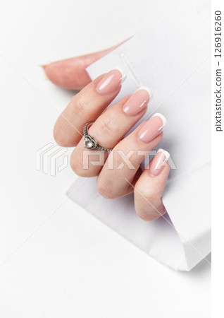 Woman hand showing french manicure and elegant ring on white background Woman hand showing french manicure and elegant ring on white background 126916260