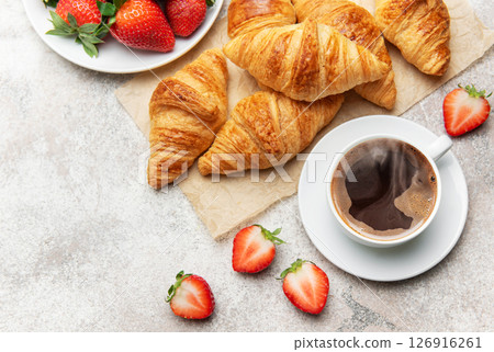 Delicious french breakfast with croissants, coffee and strawberries Delicious french breakfast with croissants, coffee and strawberries 126916261