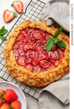 Delicious homemade strawberry galette cooling on a wire rack 126916272