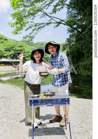Young people enjoying outdoor activities on the riverbank Young people enjoying outdoor activities on the riverbank 126916304