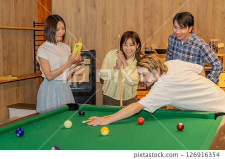 Men and women enjoying billiards Men and women enjoying billiards 126916354