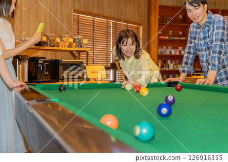Men and women enjoying billiards Men and women enjoying billiards 126916355