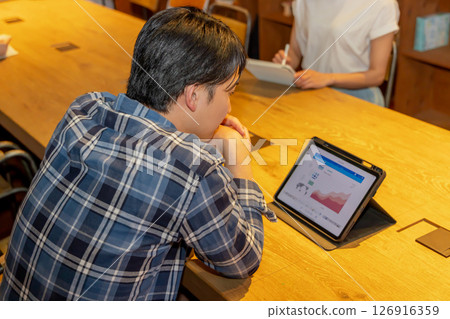 A man working in a dimly lit shared space 126916359