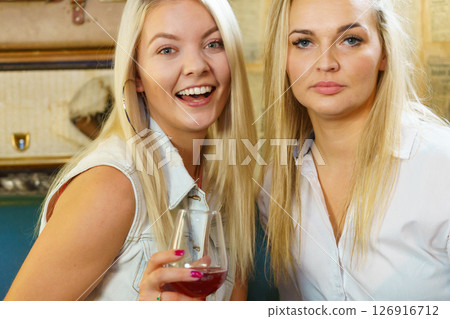 Girls talking in pub club Girls talking in pub club 126916712