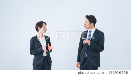 A group of male and female business people having a conversation with a smile A group of male and female business people having a conversation with a smile 126916796