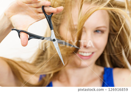 Woman with scissors ready to hair cutting Woman with scissors ready to hair cutting 126916859
