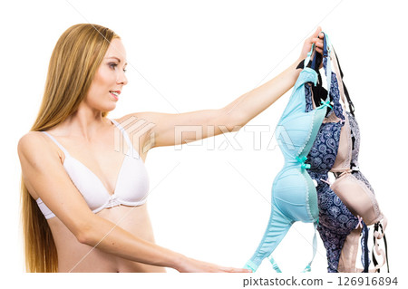 Woman holds bras, choosing 126916894