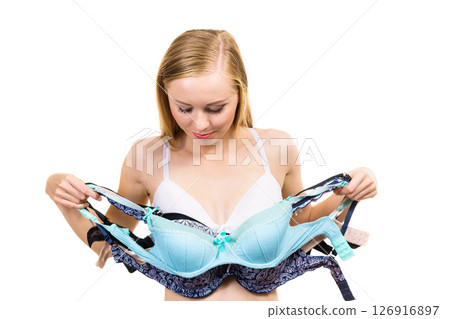 Woman holds bras, choosing Woman holds bras, choosing 126916897
