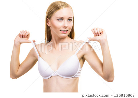 Young woman holding bra strap 126916902