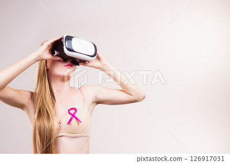 Girl in bra pink cancer ribbon and vr box 126917031