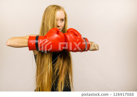 Woman in gloves playing sports boxing Woman in gloves playing sports boxing 126917088