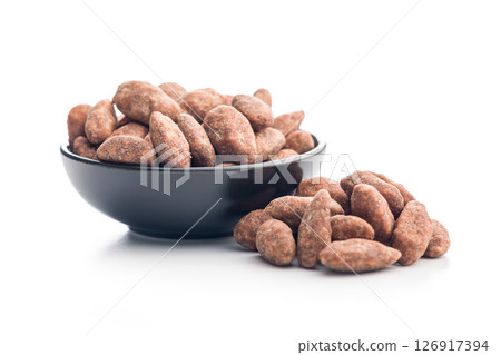 Almond nuts coated in sugar and honey in bowl isolated on white background. 126917394