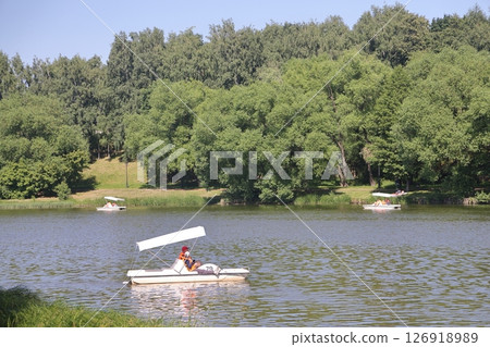 Landscape with pleasure boats on the pond, Tsaritsyno, Moscow, July 2022. Landscape with pleasure boats on the pond, Tsaritsyno, Moscow, July 2022. 126918989