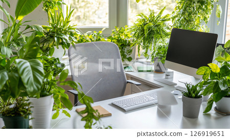 Ergonomic office chair in room with many plants near window 126919651