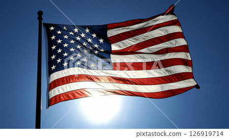 American flag waving in the wind on a sunny day 126919714