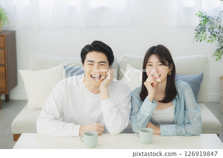 A young couple relaxing in the living room 126919847