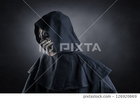 Portrait of a creepy monster with hooded cloak over dark misty background 126920669