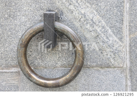 The metal ring in the granite wall symbolizes the chains of non-freedom. 126921295