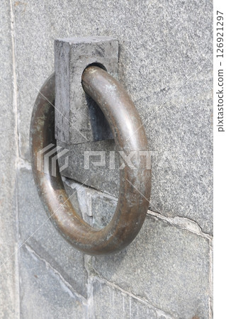 The metal ring in the granite wall symbolizes the chains of non-freedom. The metal ring in the granite wall symbolizes the chains of non-freedom. 126921297