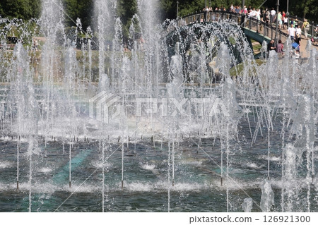 Moscow, Russia - 02 07 2022: Tsaritsynsky park with a fountain, fountain jets and park visitors. Moscow, Russia - 02 07 2022: Tsaritsynsky park with a fountain, fountain jets and park visitors. 126921300