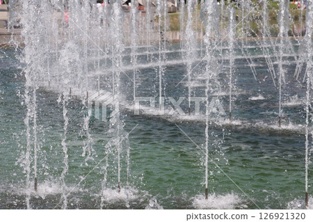 Moscow, Russia - 02 07 2022: Tsaritsynsky park with a fountain, fountain jets and park visitors. Moscow, Russia - 02 07 2022: Tsaritsynsky park with a fountain, fountain jets and park visitors. 126921320