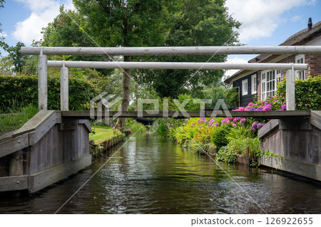 Landscape view of famous Giethoorn village in Netherlands with canals and wooden bridges 126922655
