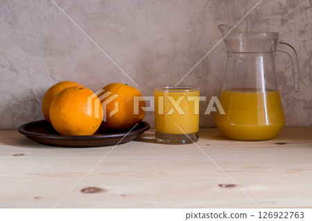 Orange is placed next to a glass of refreshing drink. 126922763