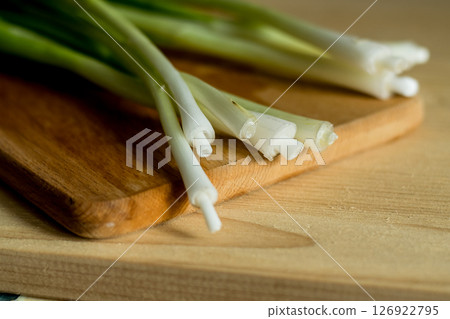 Green onions on a kitchen board 126922795