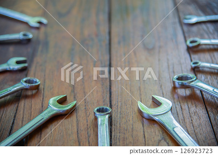 Metal bunch wrench  tools lying on dark wooden background 126923723