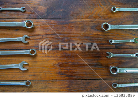 Metal bunch wrench  tools lying on dark wooden background 126923889