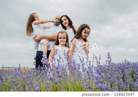 The lavender field surrounds the family with its magical atmosphere 126925047