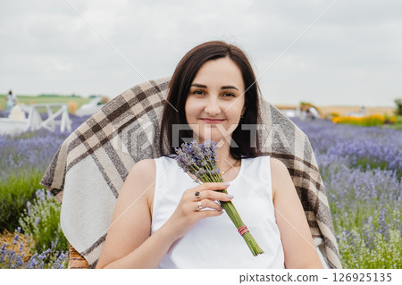 A black-haired girl is resting in a fragrant lavender field A black-haired girl is resting in a fragrant lavender field 126925135
